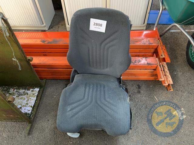 Tracto seat with extra cushion