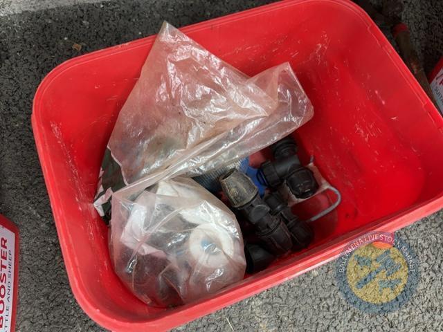 Red bucket of pipe fittings