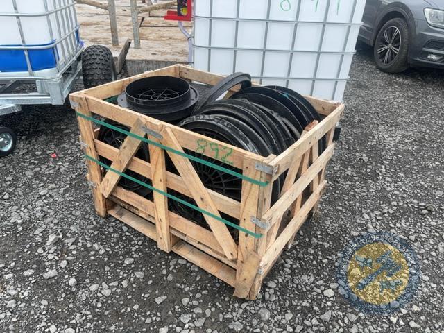 Crate of plastic man hole covers